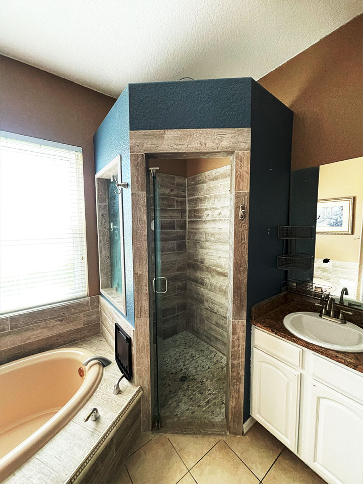 anm-contracting-projects-bathroom-interior-showcasing-vertical-shower-with-custom-wooden-construction-and-tempered-glass-doors
