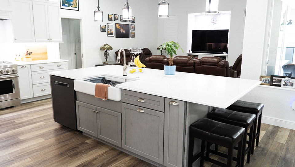 Spacious kitchen with white countertops, island seating, and wood flooring